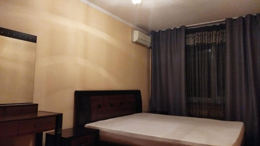 a small bedroom with a bed and a window at Apartment on Abazgaa 53-4 in Gagra