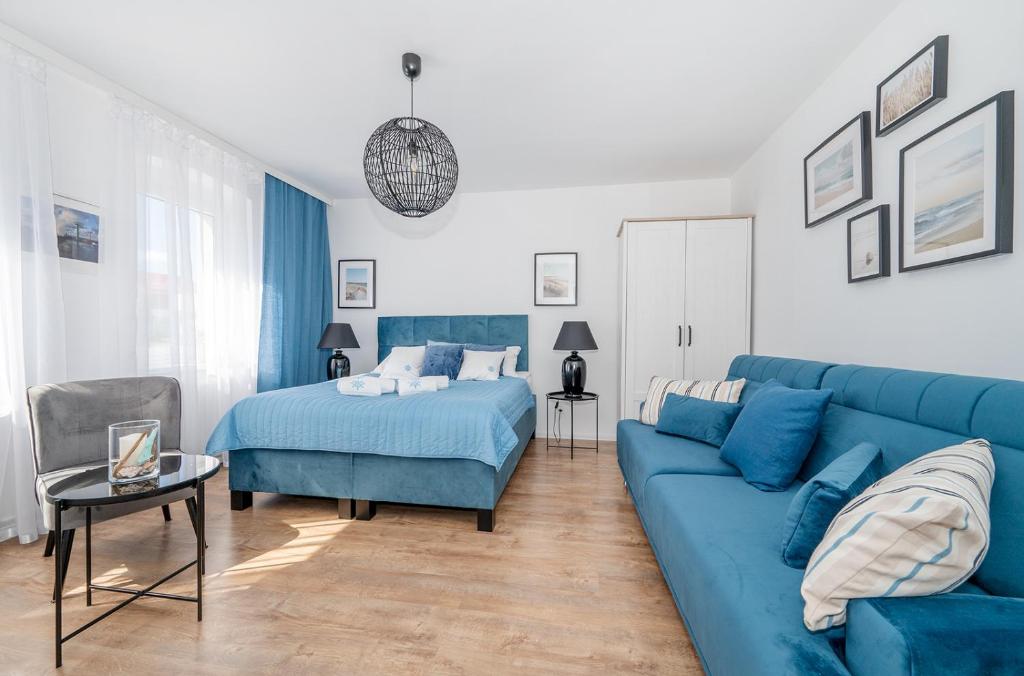 Ένα ή περισσότερα κρεβάτια σε δωμάτιο στο Apartamenty Kapitańskie