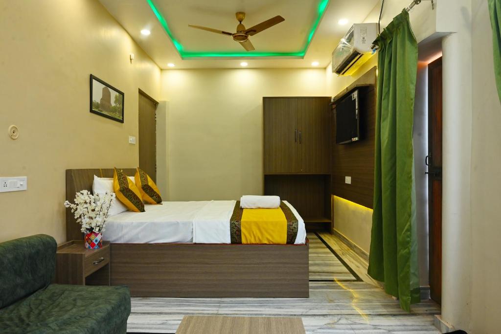 a hotel room with a bed and a ceiling at Bluebells Varanasi in Varanasi