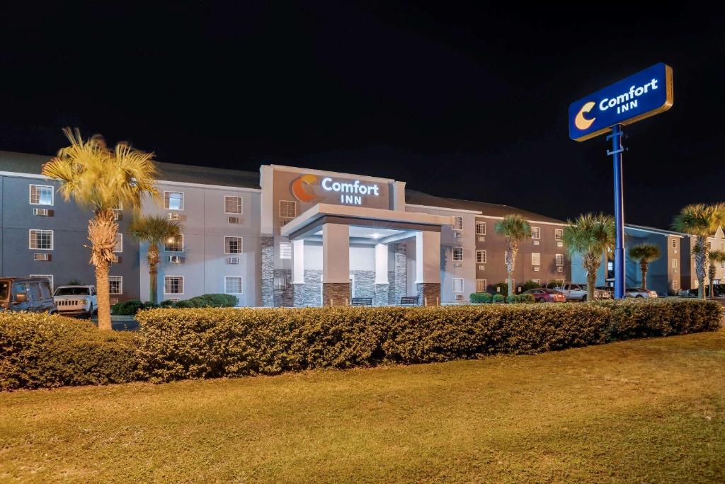 a hotel building with a sign in front of it at Comfort Inn Pensacola near NAS Corry Station in Pensacola