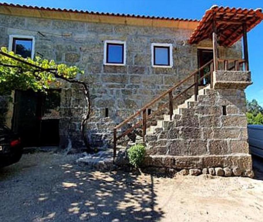 a stone house with a staircase and a building at Beautiful 2-Bed House - Marco de Canaveses in Marco de Canaveses