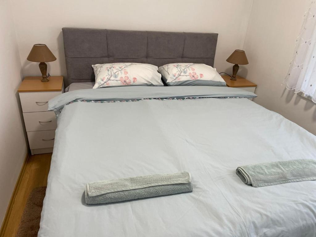 a large white bed with two pillows on it at SIMIKIC Z in Bijeljina