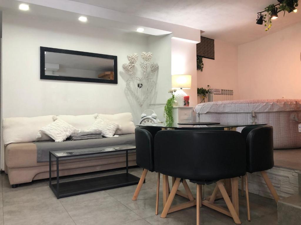 a living room with a couch and a table at Hot Jacuzzi & Ice Bath Apartment in Ika