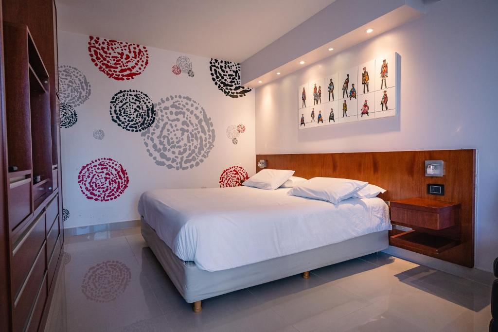 a bedroom with a white bed and red and white walls at Shoshana Hotel Boutique in Buenos Aires