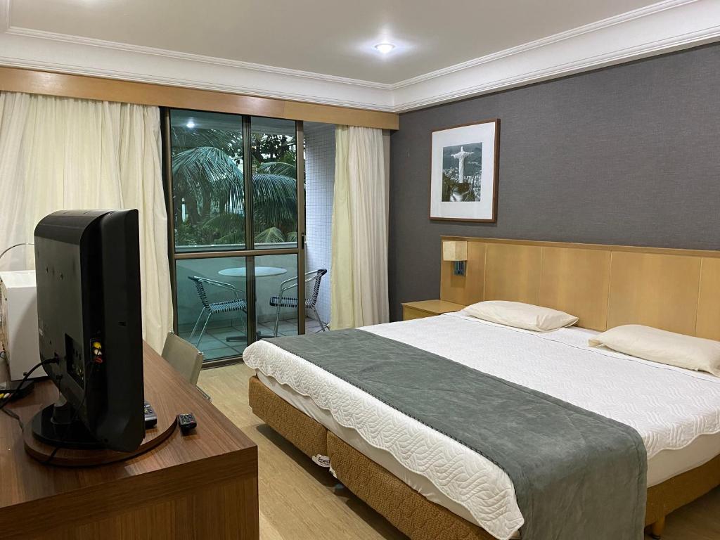 Ένα ή περισσότερα κρεβάτια σε δωμάτιο στο Flat agradável na Barra