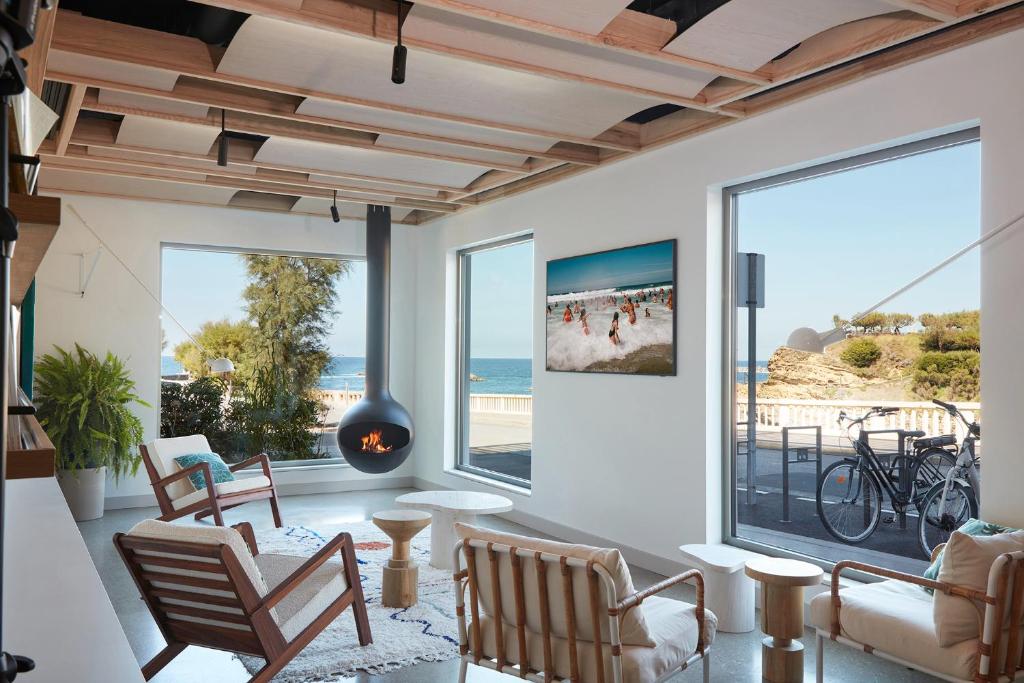 a living room with a view of the ocean at Hôtel de La Plage in Biarritz