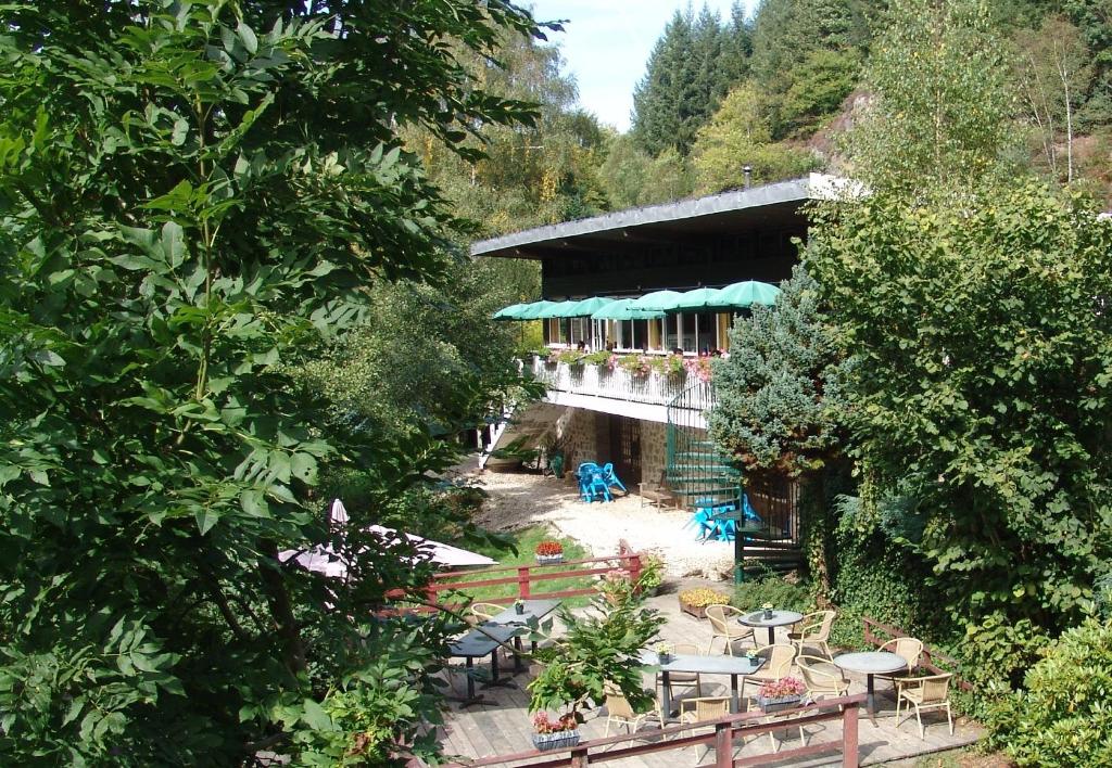 un edificio con mesas y sillas en un jardín en Chalet du Montal, en Dun-les-Places