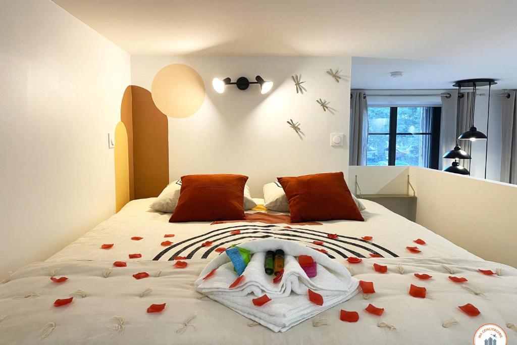a bedroom with a bed with red roses on it at l&#39;Orient-Express - Jacuzzi SPA - Parking - Loft in Le Havre