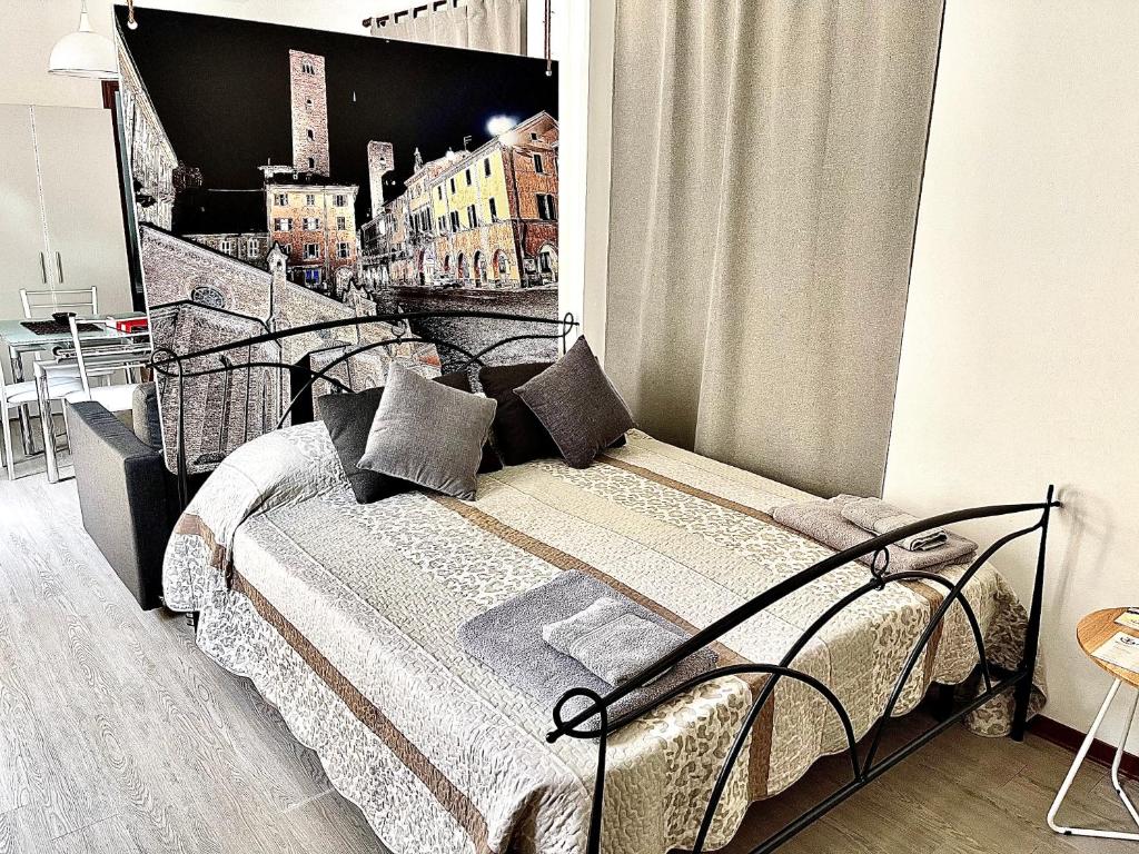 a bedroom with a bed with a poster on the wall at 10mt dal Duomo Ca del Duomo in Alba