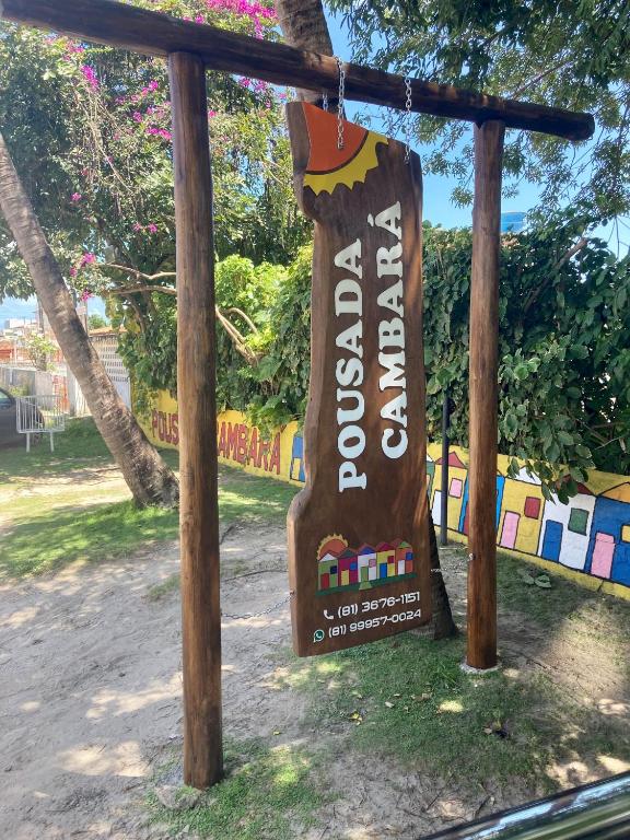 a sign for a restaurant in a park at Pousada Cambará in Tamandaré