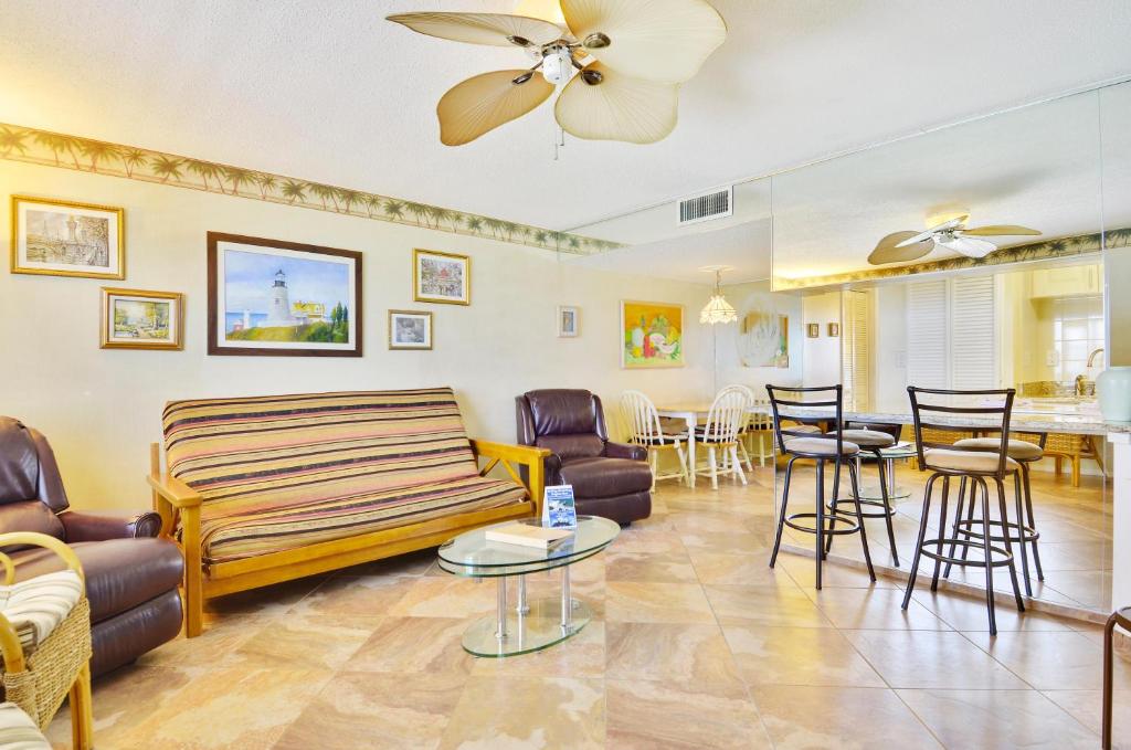 a living room with a couch and chairs and a table at Sunset Chateau 506 - Premier in St Pete Beach