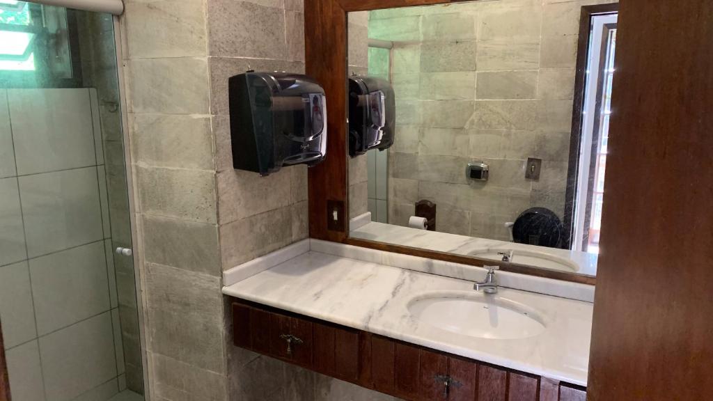 a bathroom with a sink and a mirror at Gajah in Joinville