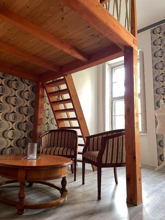 a living room with two chairs and a table at Szeged-Vár in Szeged