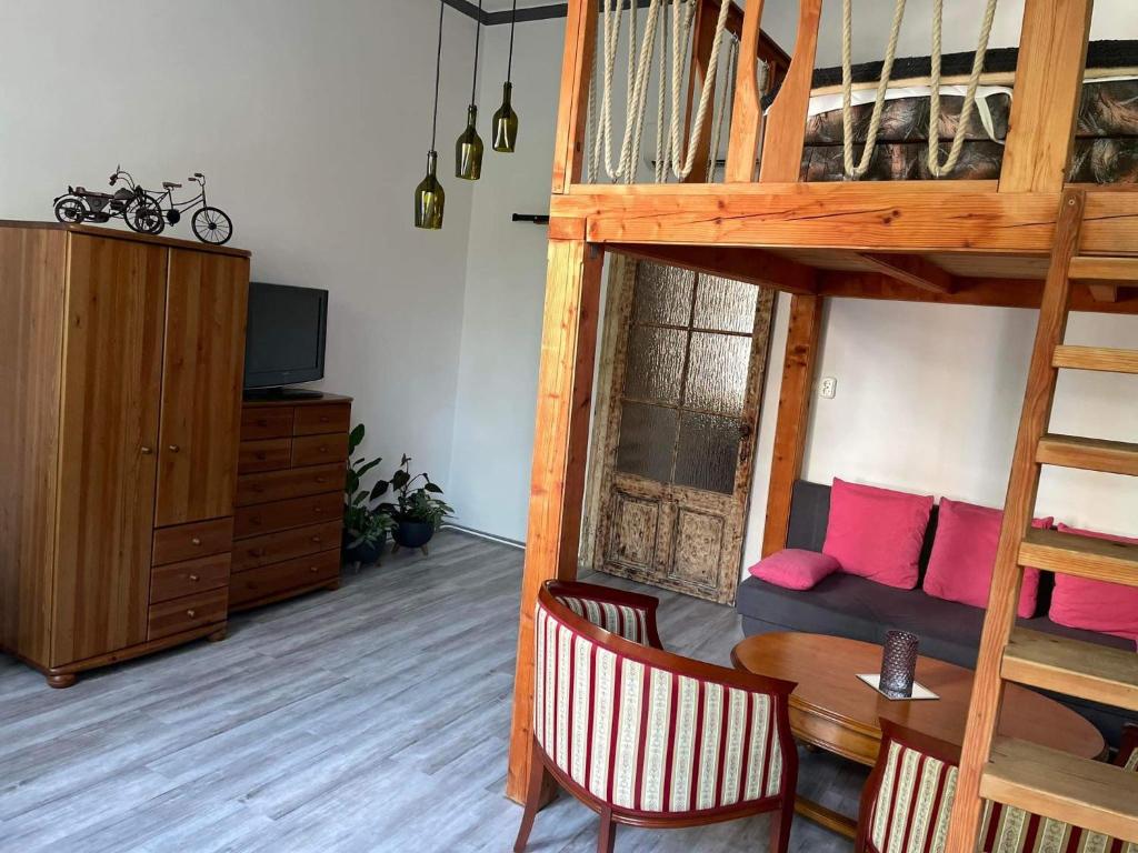 a living room with a loft bed and a dining table at Szeged-Vár in Szeged