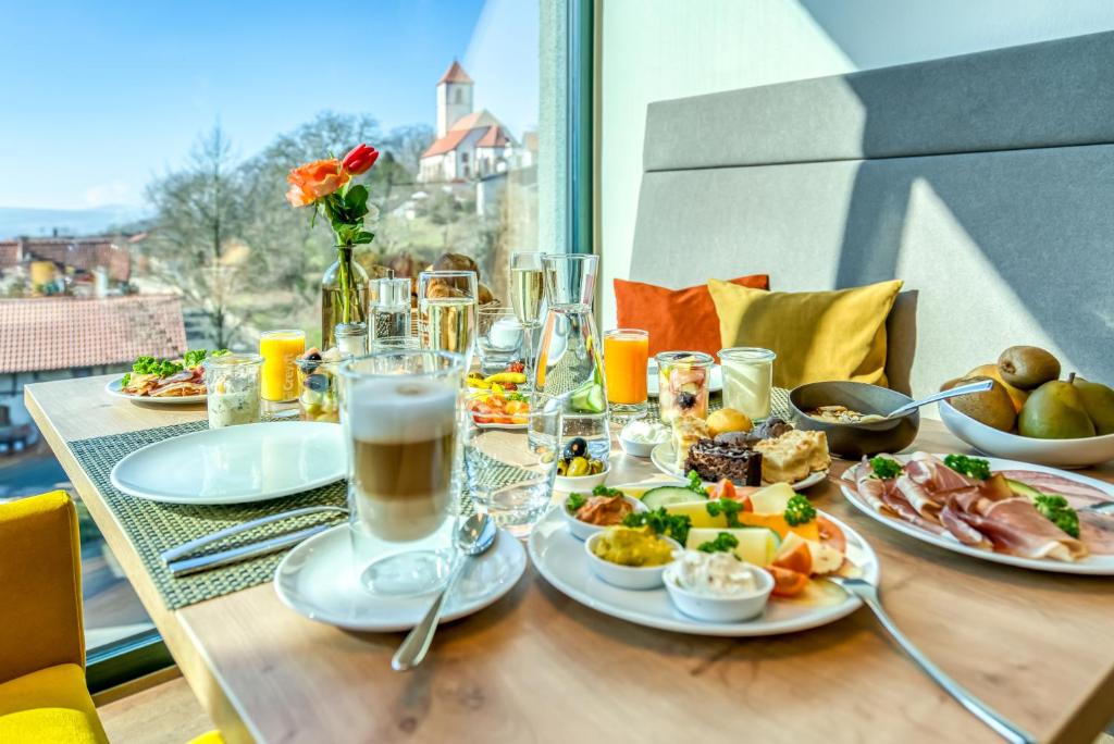 a table with plates of food and drinks on it at Guesthouse Beckmann in Göttingen