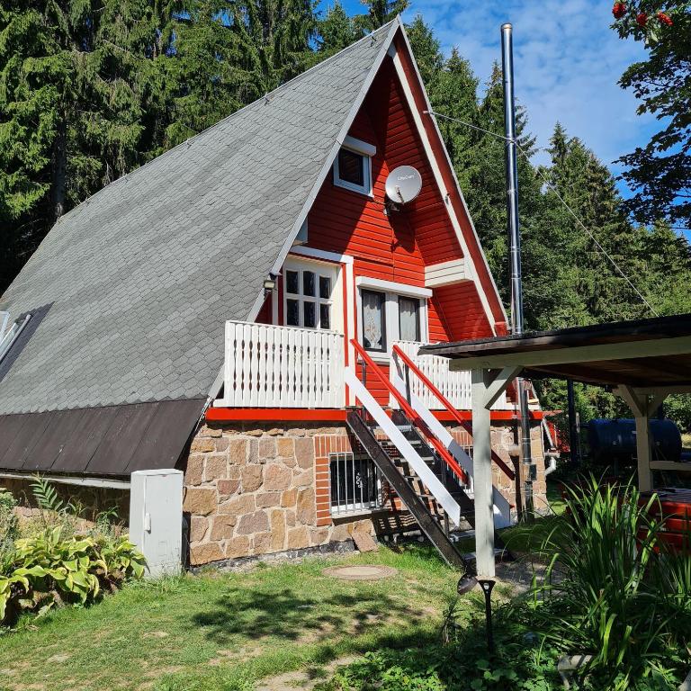 ein rotes Haus mit einem Mansarddach in der Unterkunft Wanderhütte Zum Bernhardsthal in Bernhardsthal