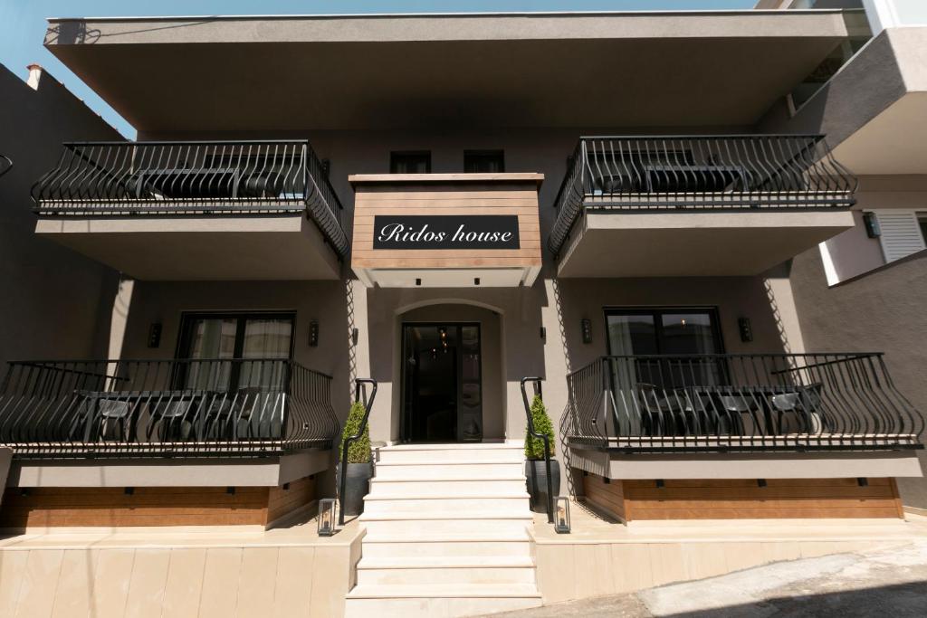 un edificio con escaleras que conducen a la entrada de un salón de belleza en ridos house en Néos Marmarás