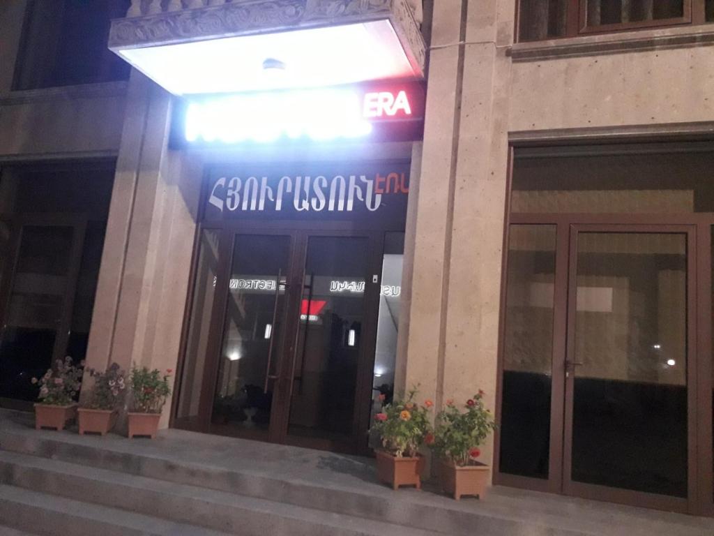 a building with a sign on the front of it at ERA Hotel in Gyumri