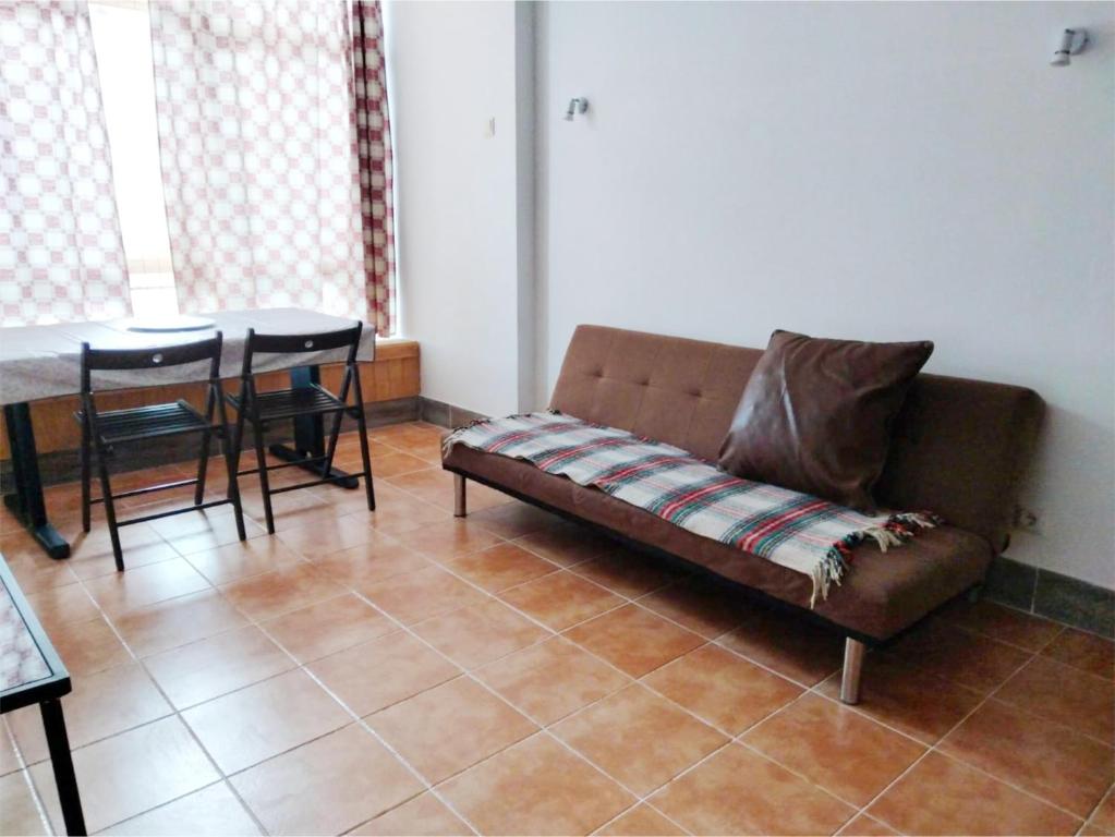 a living room with a couch and a table at Casa Terra Cota - Almada in Almada