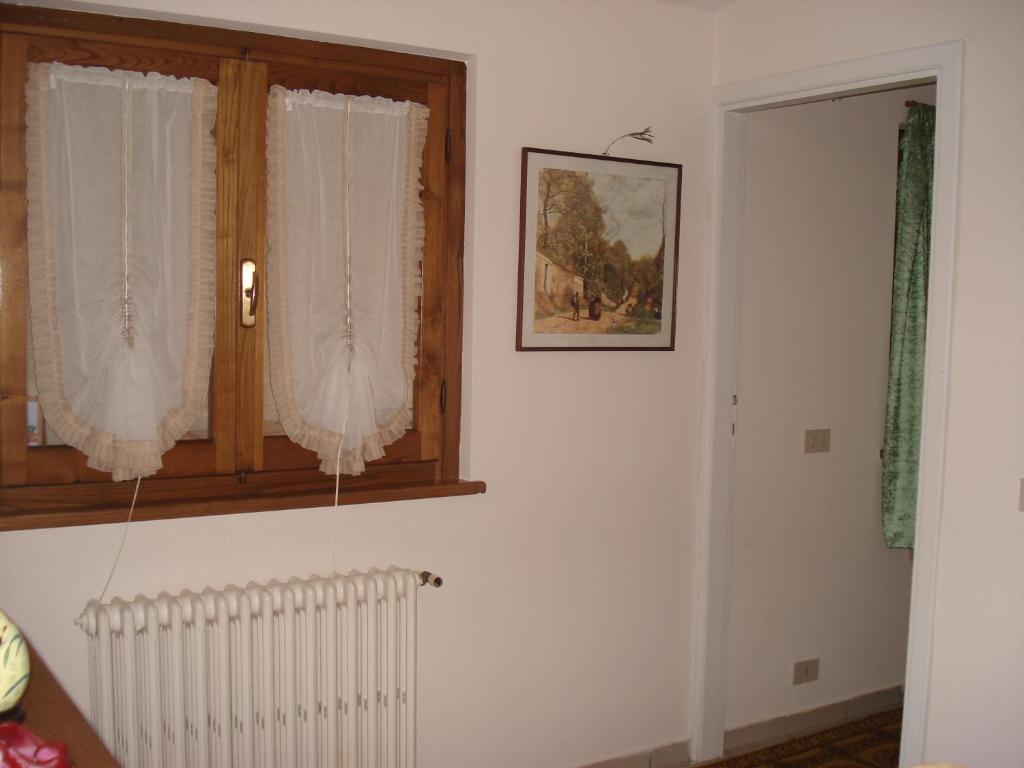 a living room with a window and a radiator at Mimi House in Lido di Camaiore