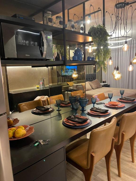 a kitchen with a table with plates of food on it at Flat Moderno e decorado Lapa-RJ in Rio de Janeiro
