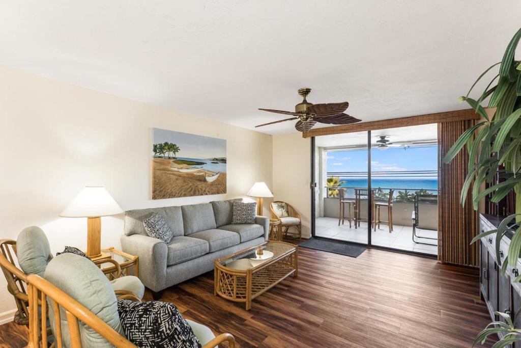 a living room with a couch and a table at Holualoa Bay Villas#105 in Kailua-Kona