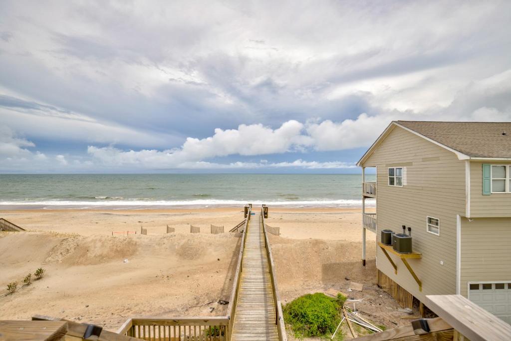 a beach house with a boardwalk leading to the beach at The Lazy Beagle in North Topsail Beach