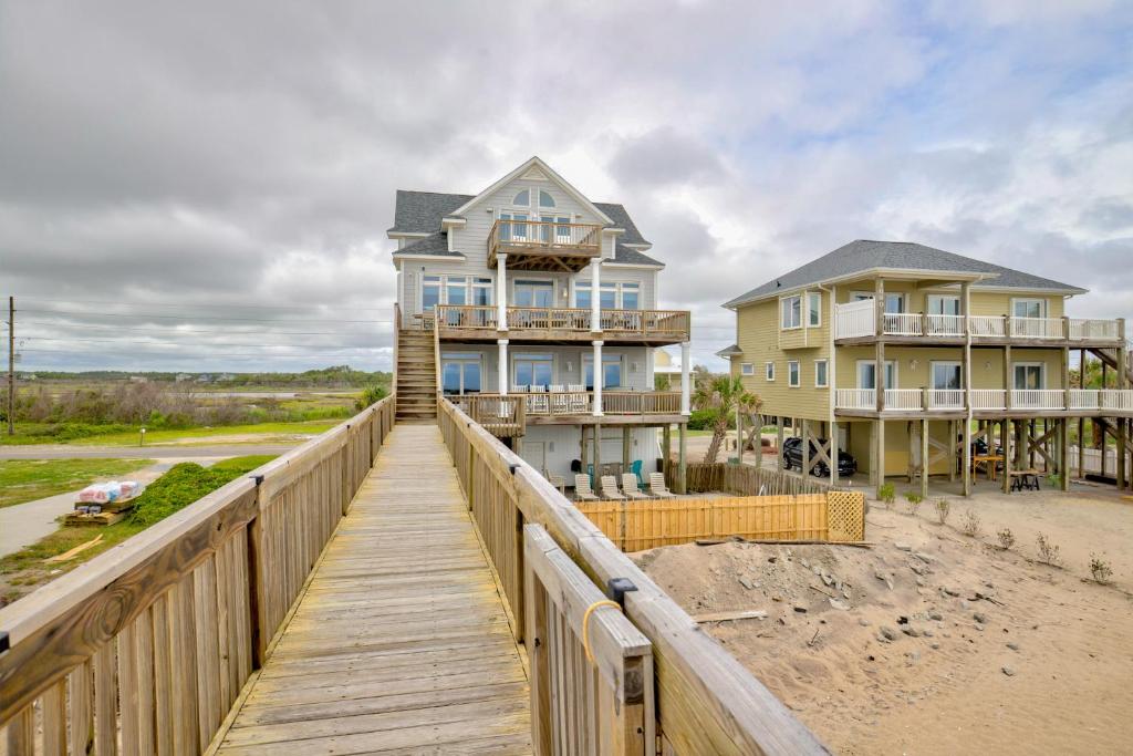 a house on a boardwalk next to a beach at The Lazy Beagle in North Topsail Beach