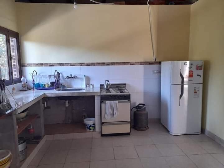 a kitchen with a stove and a refrigerator at Casa Carina in Yala