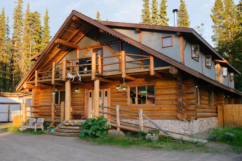 a log cabin with a gambrel roof at Arctic Divide Lodge in Dease Lake