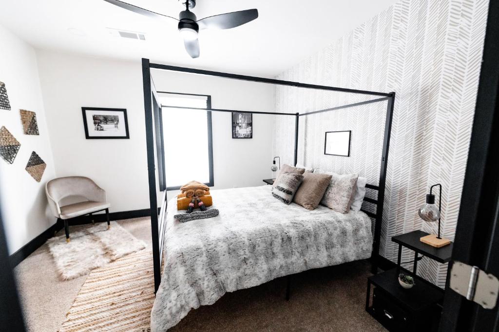 a bedroom with a black canopy bed and a chair at Cozy & Stylish Home in Downtown Atlanta in Atlanta