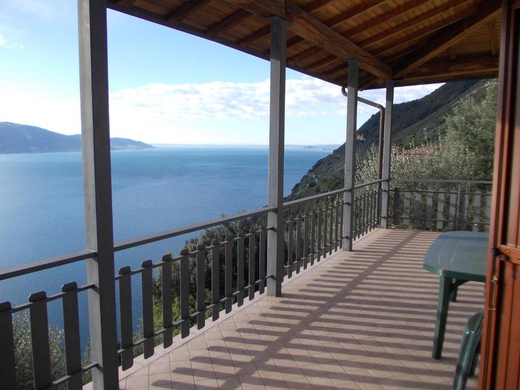 a balcony of a house with a view of the ocean at Villa Venturelli in Tignale
