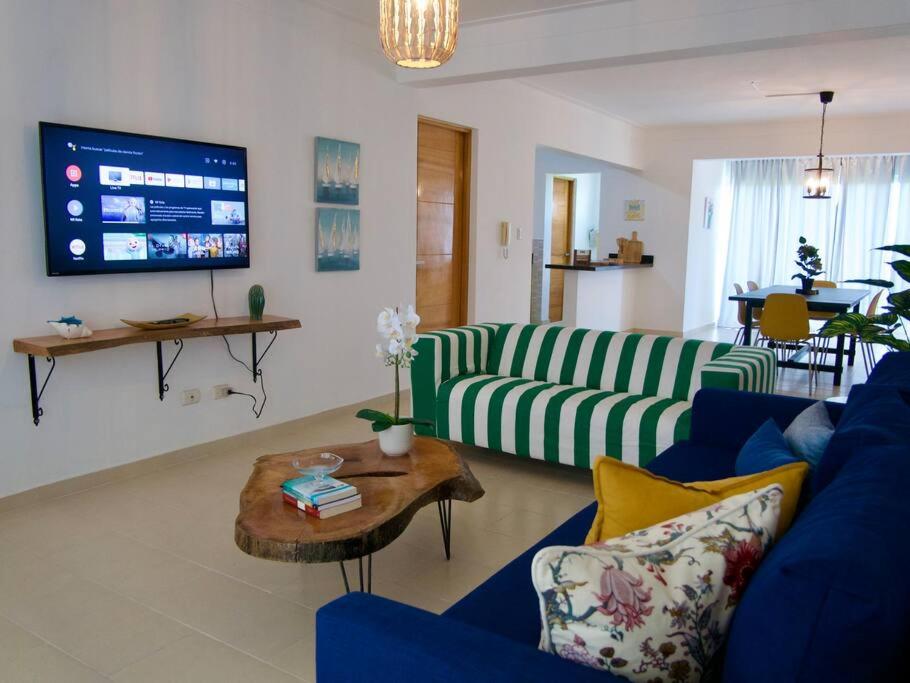 a living room with a couch and a table at Lovely condo at Blue Sea Tower near Juan Dolio beach in Juan Pedro