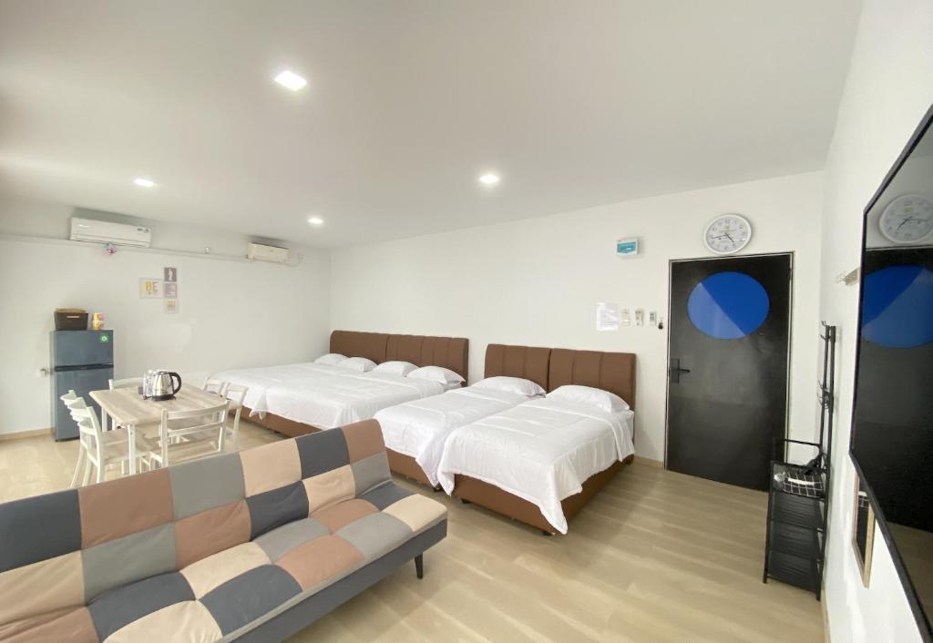 a hospital room with four beds and a couch at CN Homestay A3 Floor 1 at Nagoya Hill Mall in Nagoya