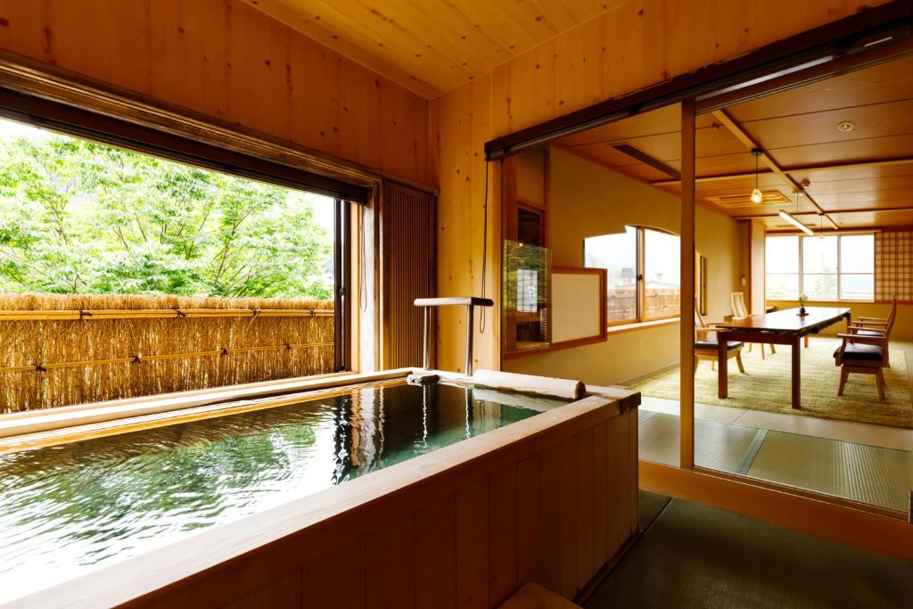 an indoor swimming pool in a house with a large window at Suihoen in Gero