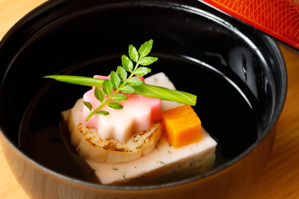 a bowl of food with cheese and vegetables in it at Suihoen in Gero