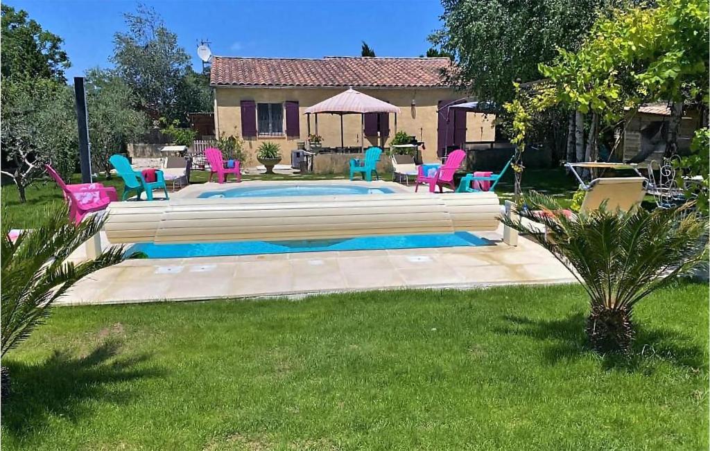 a yard with a pool with chairs and a house at Amazing Home In Montlimar With Outdoor Swimming Pool in Montélimar