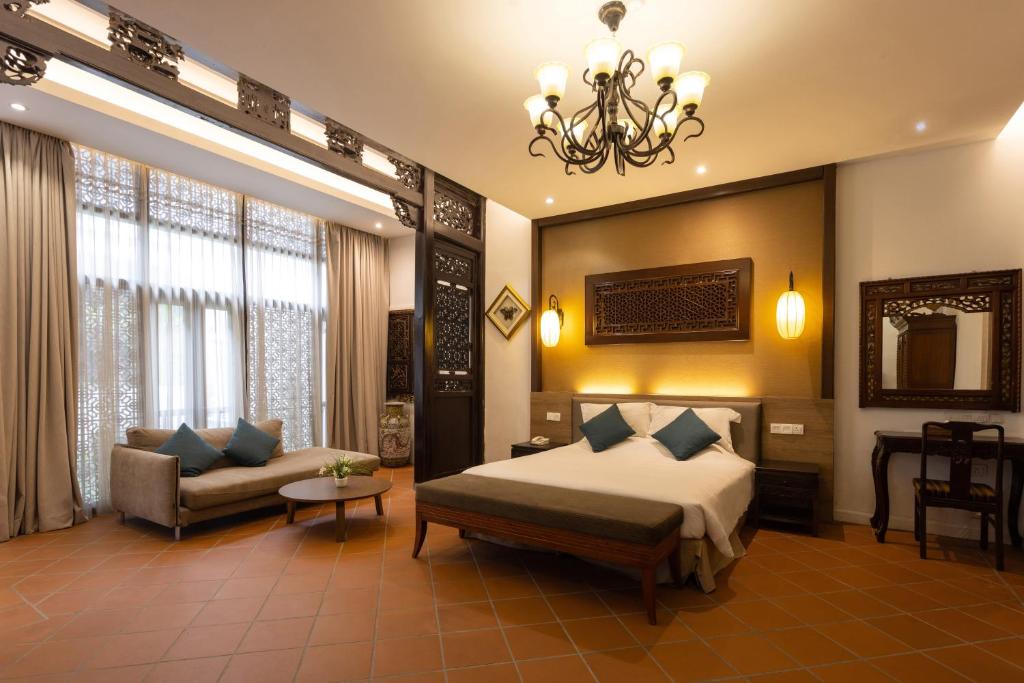 Postel nebo postele na pokoji v ubytování Hotel Puri Melaka