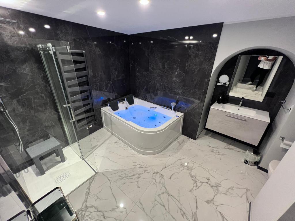 a large bathroom with a tub and a sink at Le Porte luxury apartment in Aosta