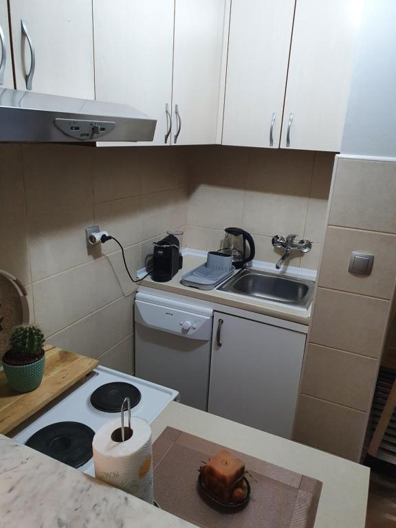 a small kitchen with a stove and a sink at Little Sea Stars, Tivat in Tivat