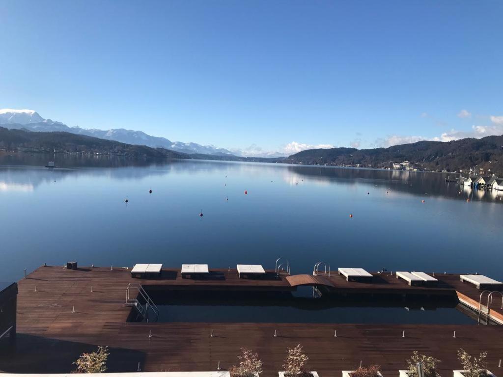 a view of a large lake with a dock at Apartment Lake`s in Pörtschach am Wörthersee