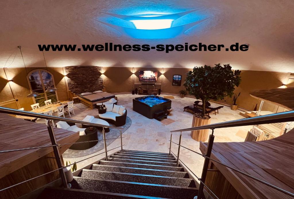a large room with a staircase with a couch and a couch at Wellness-Speicher in Freital
