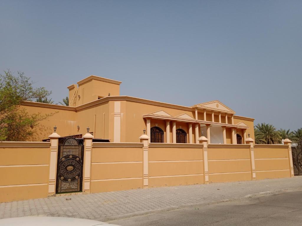 a large house with a fence in front of it at Ahlam Villa Musandam in Khasab