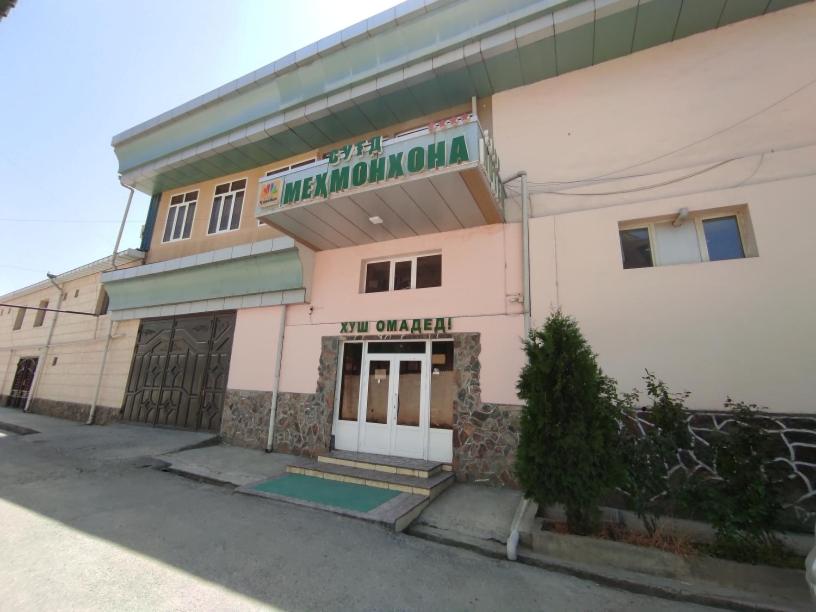 a building with a sign that reads the car dealer at Hotel SUGD & Guest House in Panjakent