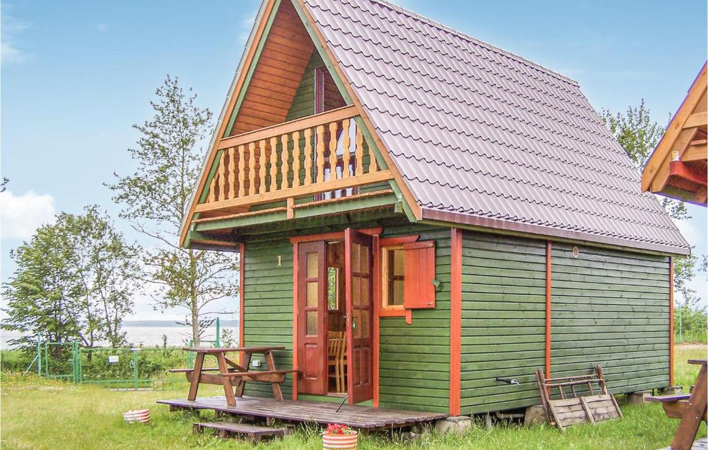 a small green house with a gambrel roof at Lovely Home In Osieki With Kitchenette in Osieki