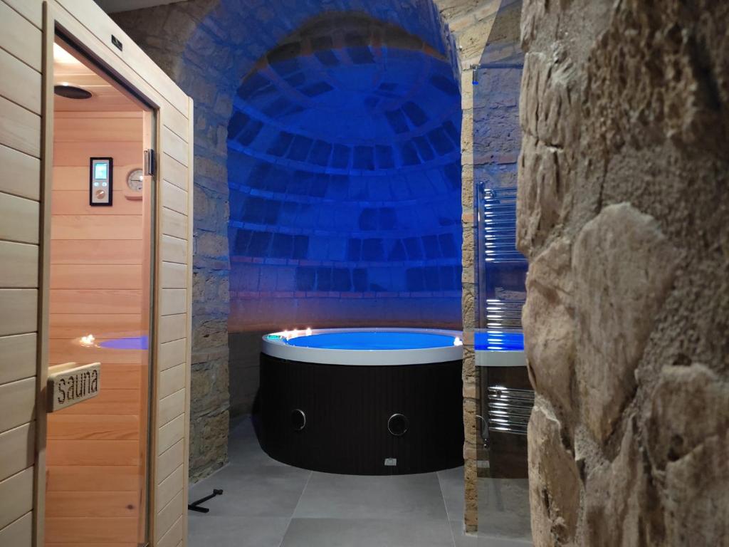 y baño con bañera grande en una pared de piedra. en Casa Patou, en Ponte