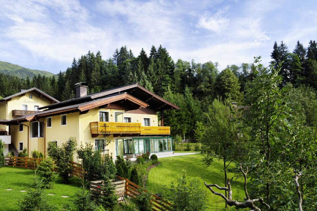 a house in the middle of a field with trees at Haus Diana in Wagrain