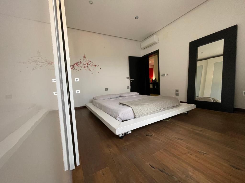 a bedroom with a bed and a large mirror at Residenza MaryLou in Porto SantʼElpidio