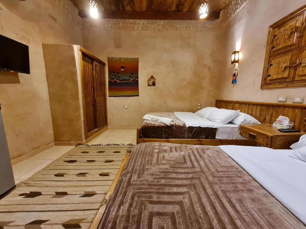 Postel nebo postele na pokoji v ubytování Qasr El salam