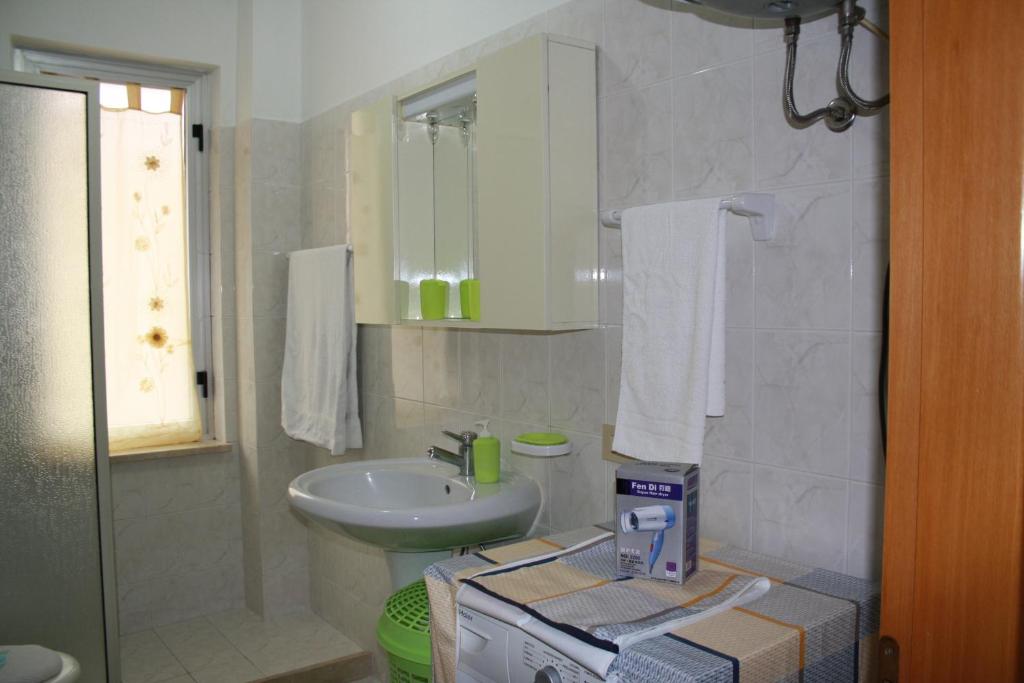 a bathroom with a sink and a toilet and a sink at GB Case Vacanze Sicilia in Balestrate